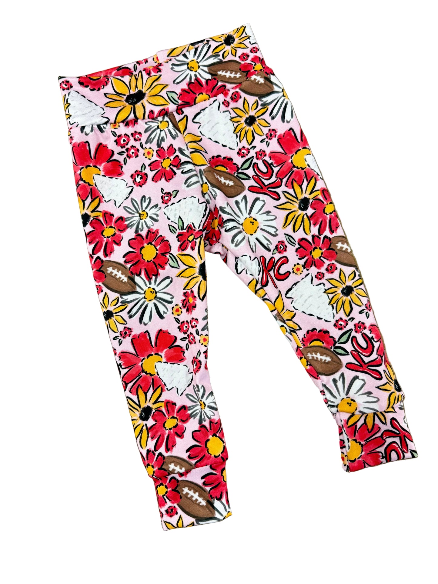Floral-patterned leggings with football designs on a textured surface