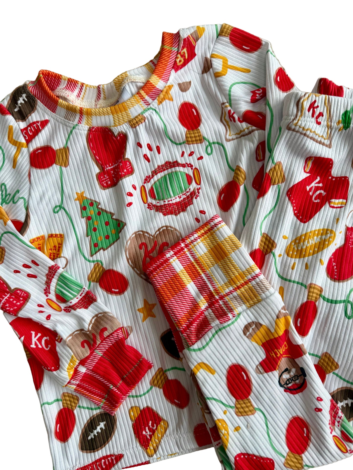Children's Kansas City football  pajama set with cookie pattern on a textured surface