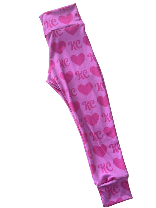 Pink fabric with heart patterns on a wooden floor