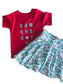 Red shirt with 'Game Day' text and a white baby blanket with 'KC' pattern on a white surface
