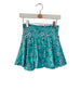 Teal skirt with kc soccer pattern hanging on a brick wall