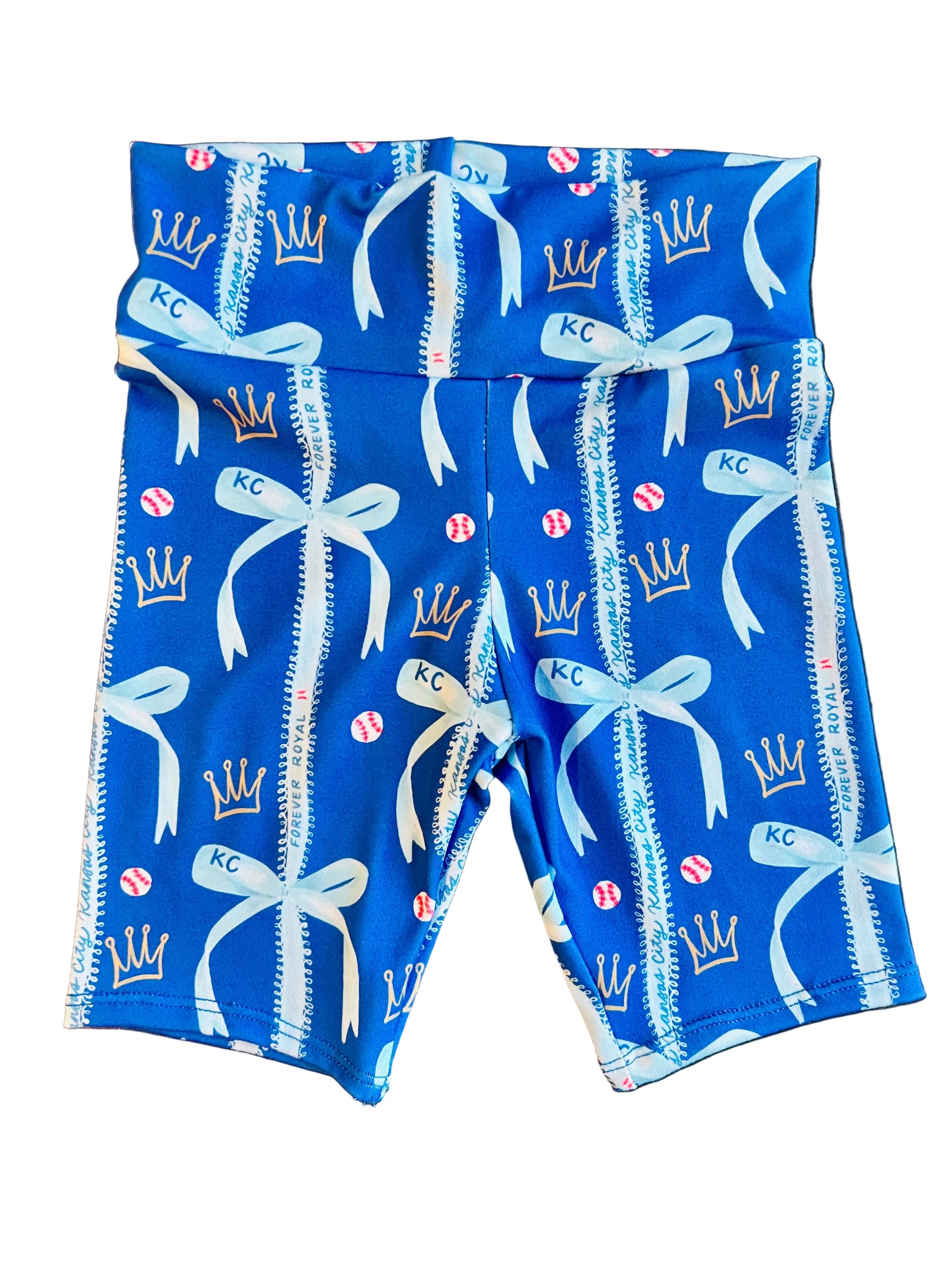 Blue fabric with KC bows and baseballs on white surface